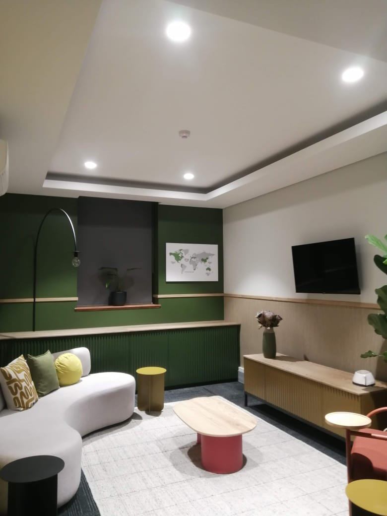 Office breakout lounge with downlights in a stepped bulkhead ceiling